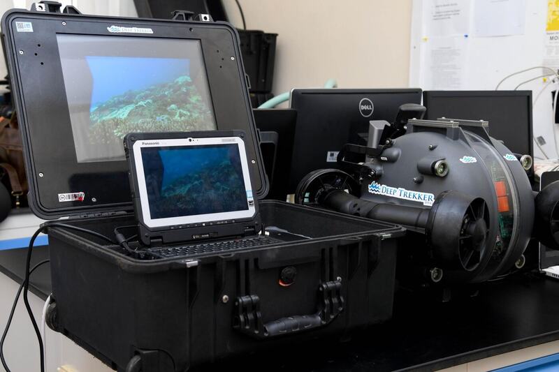 Deep Trekker underwater ROV control station with a rugged Toughbook displaying live coral-reef footage